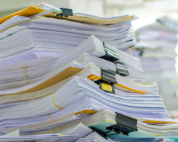 piles of documents and papers waiting to be shredded